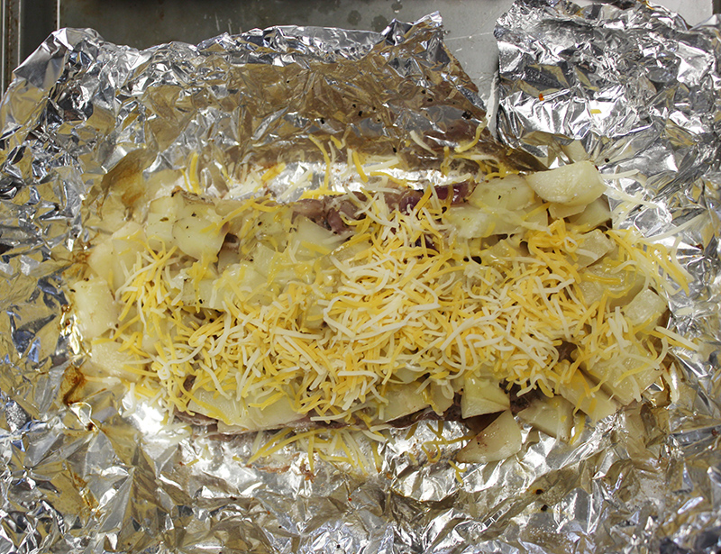shredded cheese sprinkled on cooked hobo dinner ingredients