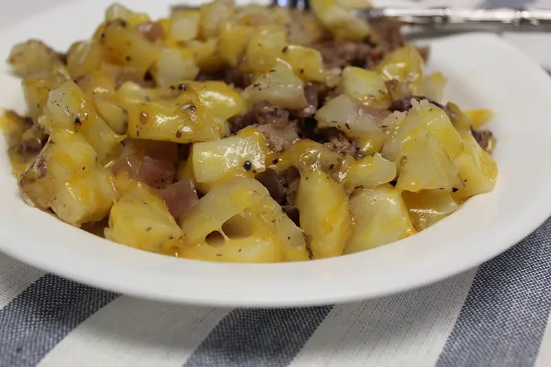 hobo dinner for two with hamburger in a bowl with a fork