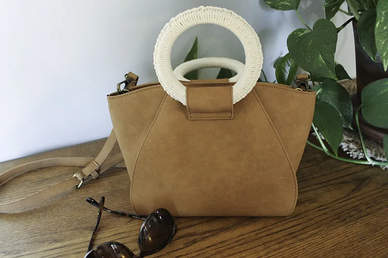 brown leather purse with macrame detail on the handle